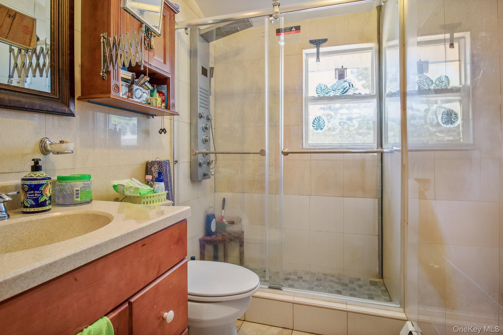 135-06 62nd Road Queens, NY 11367 - Photo 13 of 20 a bathroom with a sink toilet and shower