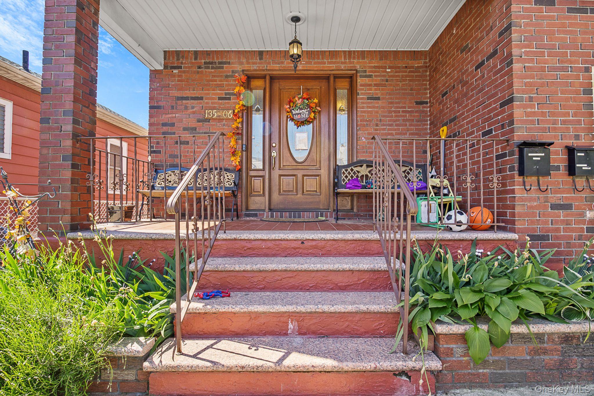 135-06 62nd Road Queens, NY 11367 - Photo 2 of 20 a front view of a building with garden