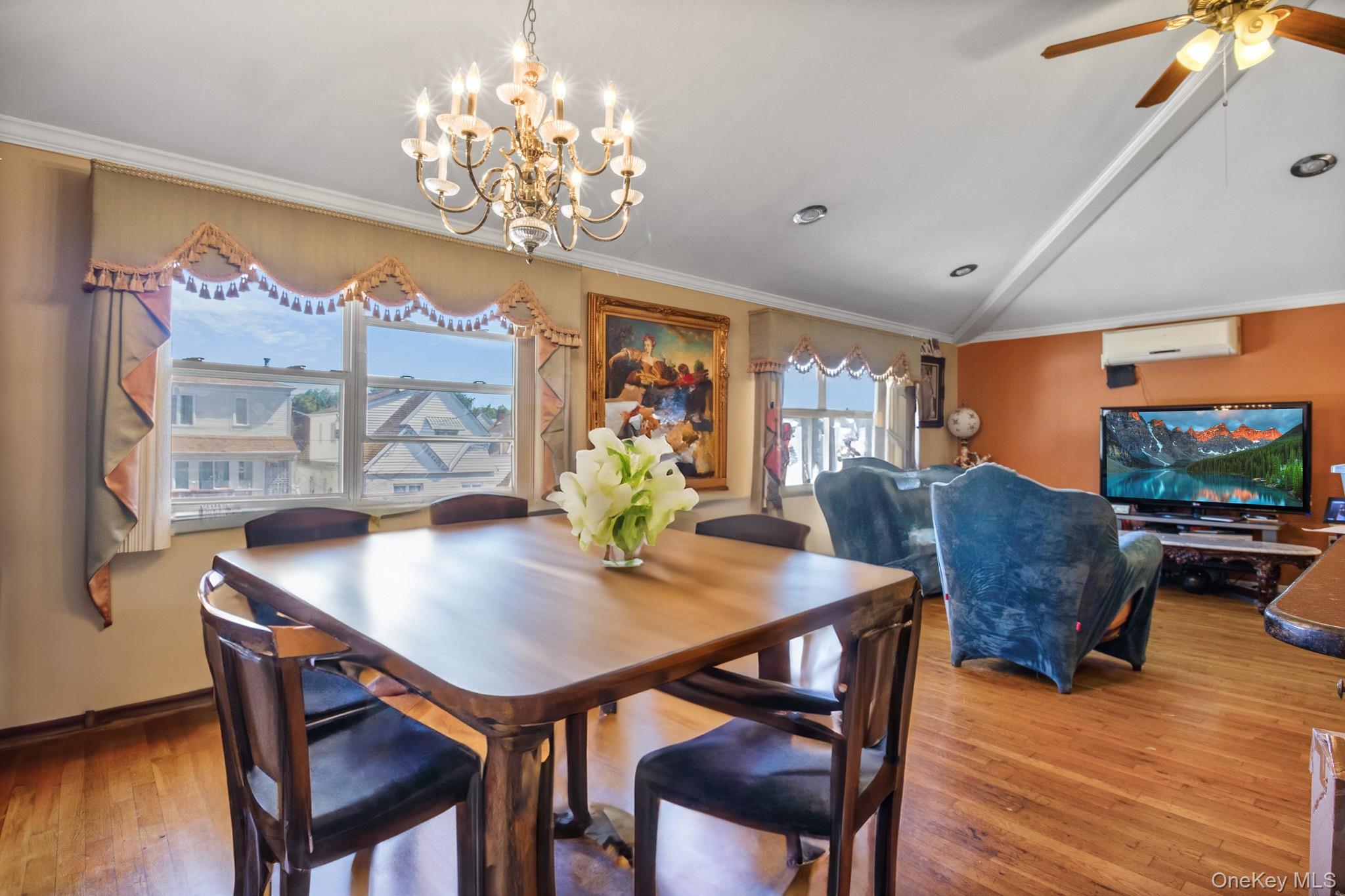 135-06 62nd Road Queens, NY 11367 - Photo 6 of 20 a view of a dining room with furniture a chandelier and wooden floor