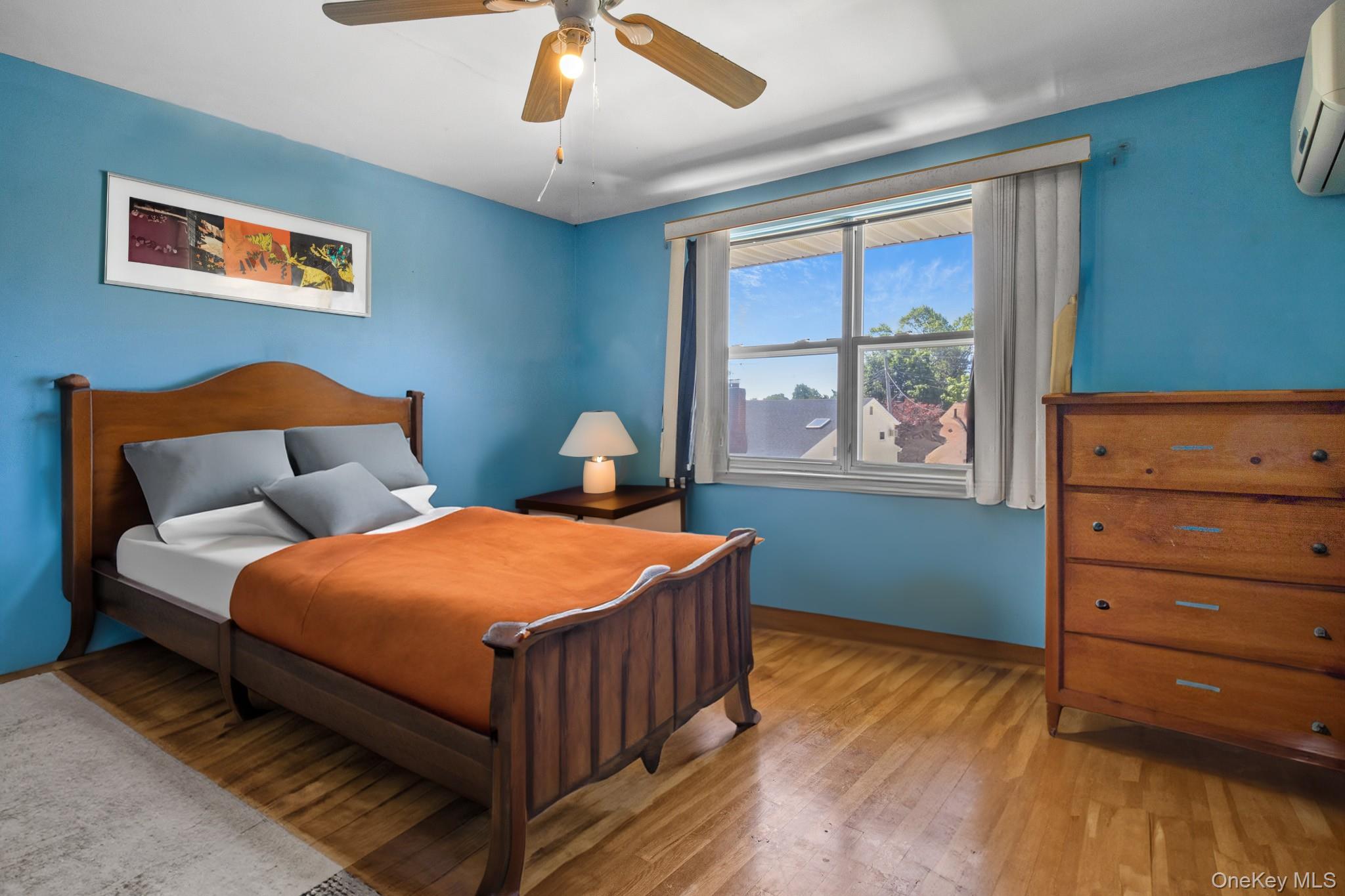 135-06 62nd Road Queens, NY 11367 - Photo 10 of 20 a bedroom with a bed and window