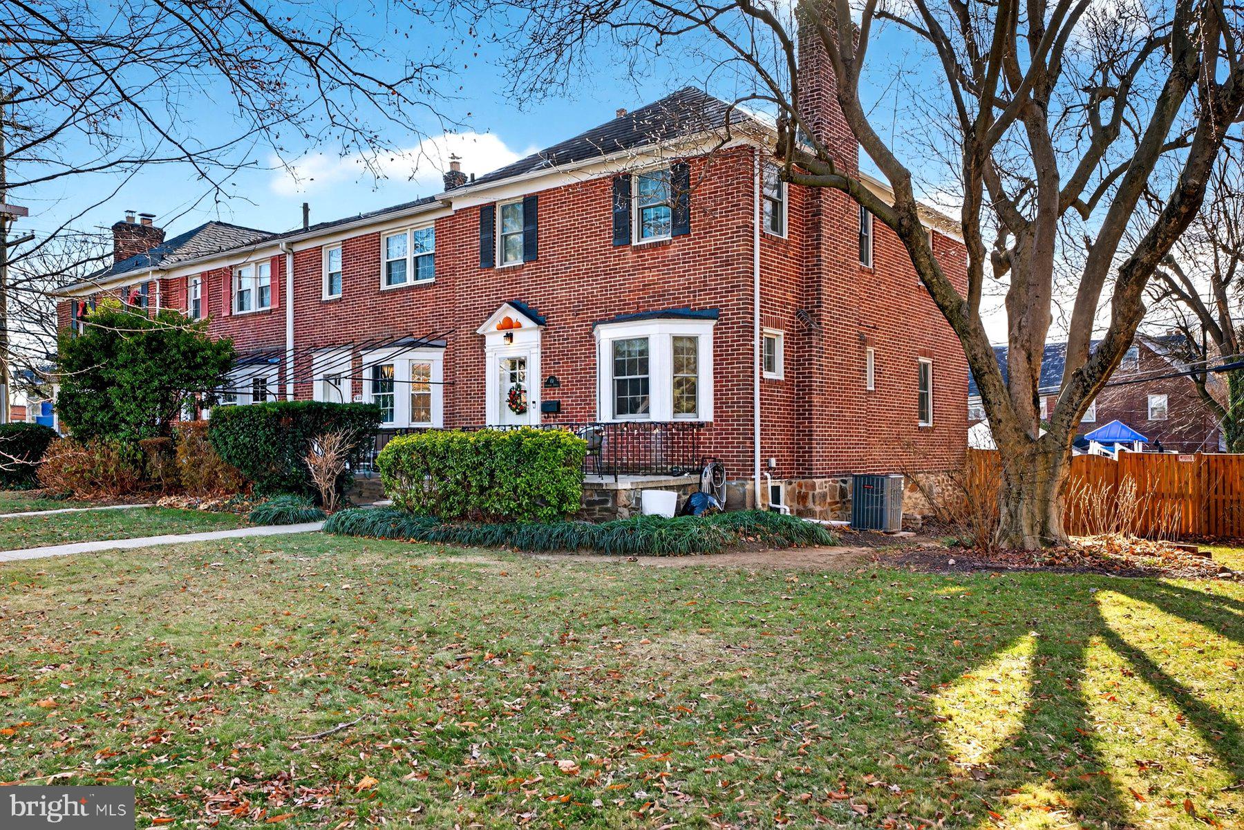a view of a brick building next to a yard