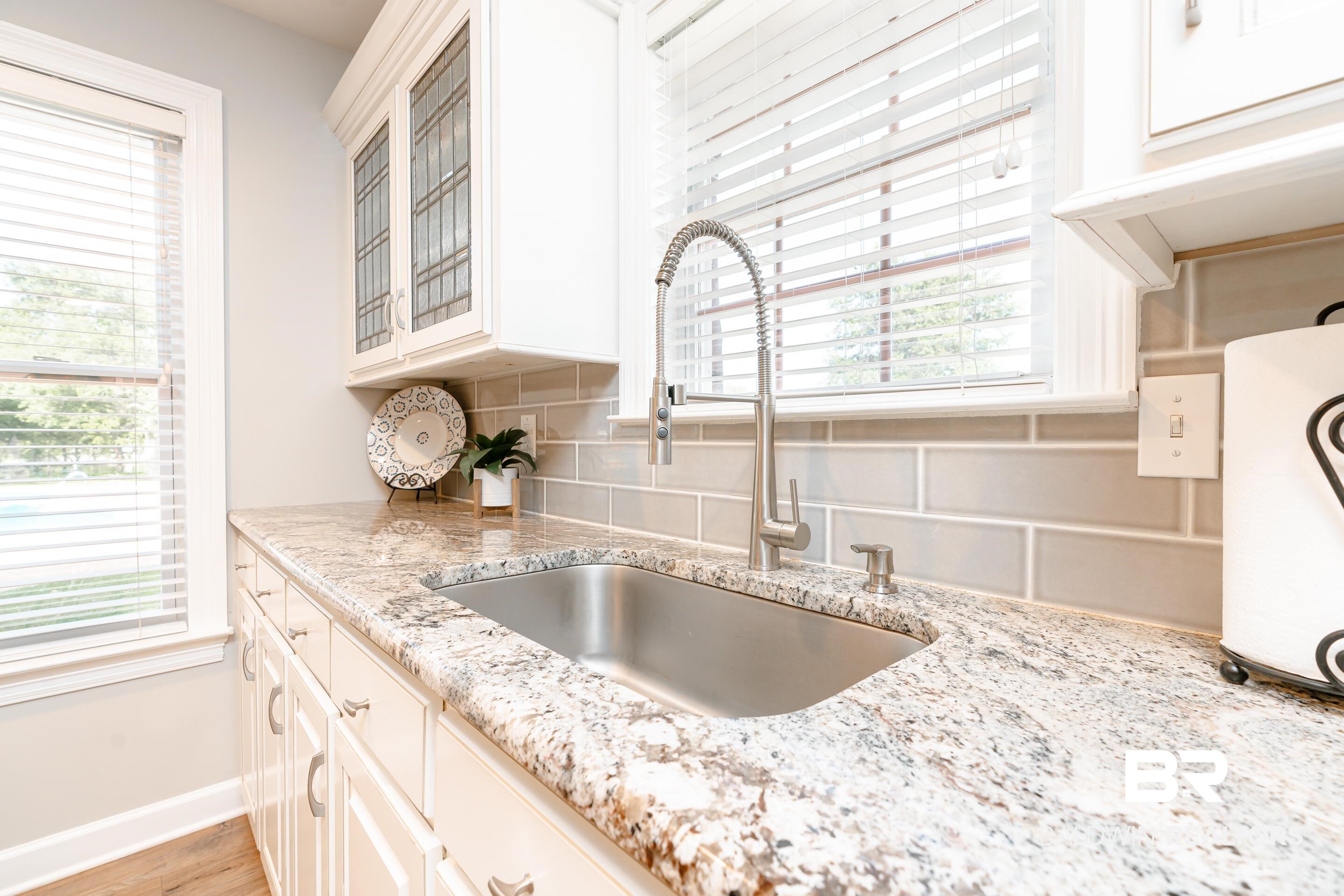 9477 Deerfield Drive Irvington, AL 36544 - Photo 13 of 58 Kitchen with light hardwood / wood-style floors, a wealth of natural light, sink, and backsplash