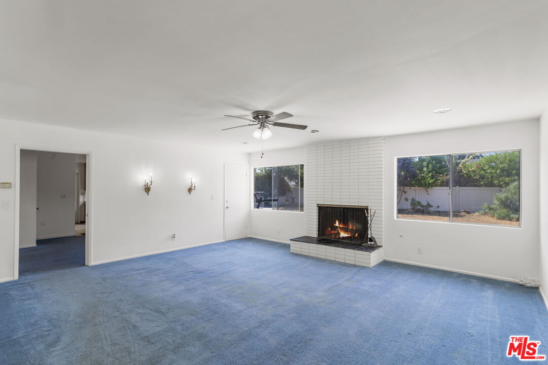 5279 Falkirk Avenue Riverside, CA 92506 - Photo 11 of 44 a living room with fireplace and windows