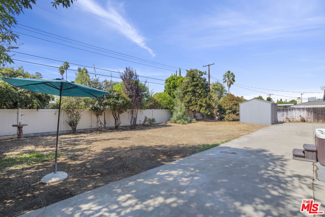 5279 Falkirk Avenue Riverside, CA 92506 - Photo 27 of 44 a backyard of a house with table and chairs under an umbrella