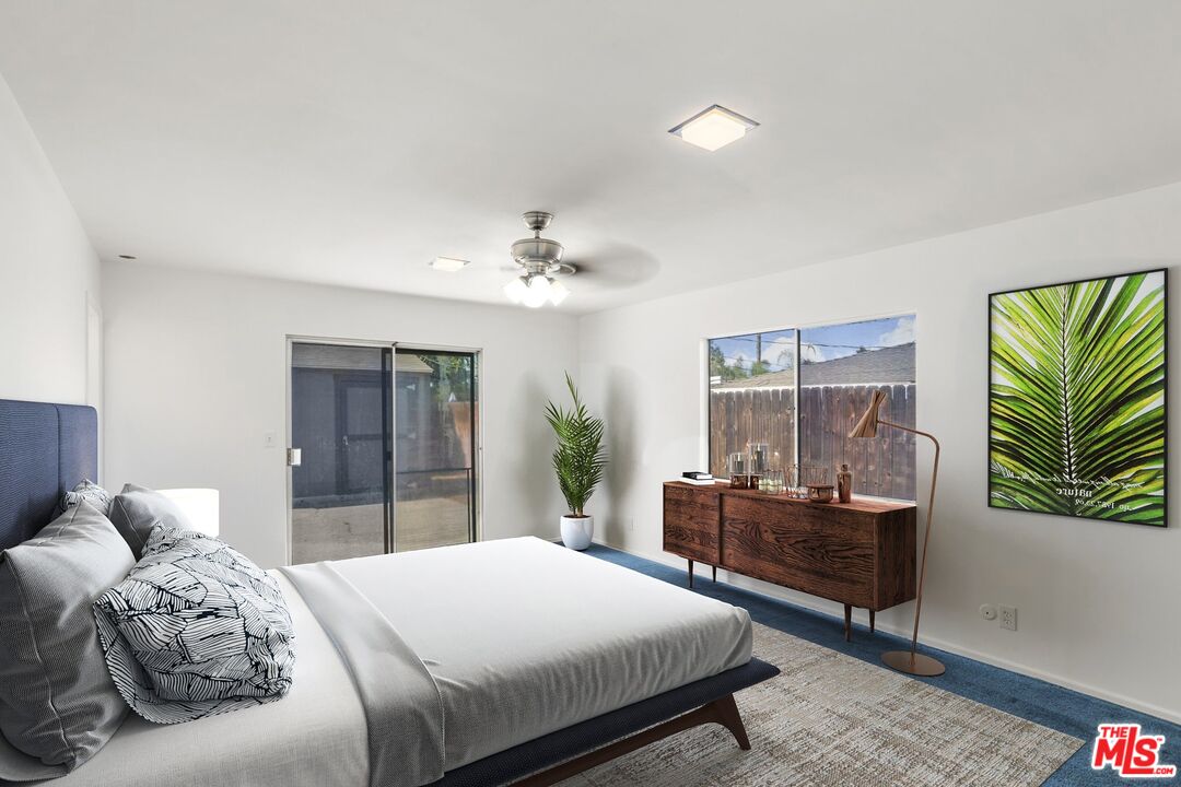 5279 Falkirk Avenue Riverside, CA 92506 - Photo 8 of 44 a bedroom with a large bed and a chandelier