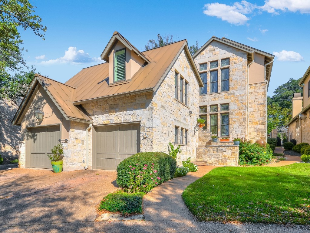a front view of a house with a yard and garage