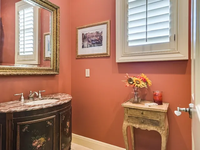 a bathroom with a stove a sink and a window