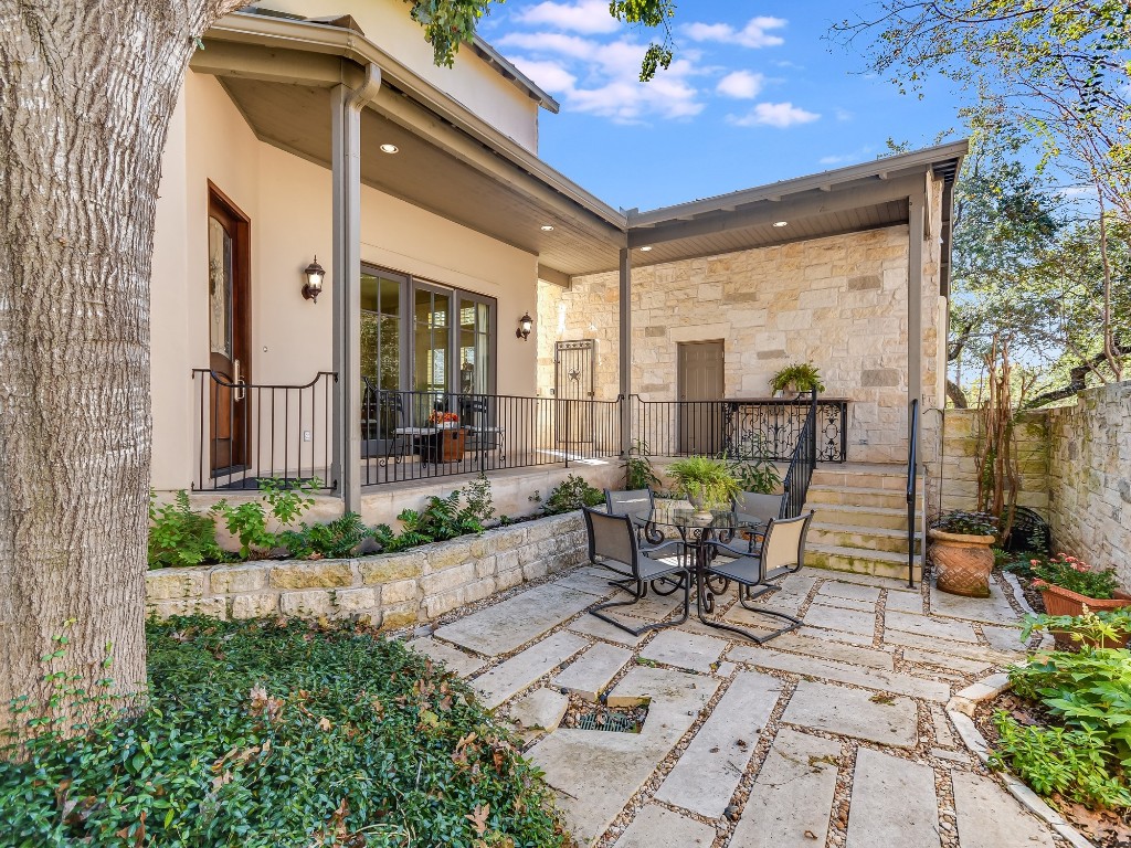 2510 West 35th Street Austin, TX 78703 - Photo 19 of 25 a view of a patio with table and chairs potted plants and floor to ceiling window and potted plants
