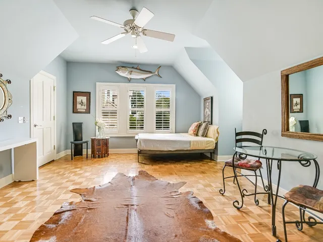 a bedroom with furniture and a large window