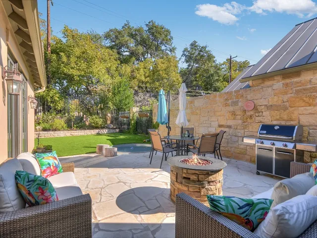 a view of a patio with couches chairs and a fire pit