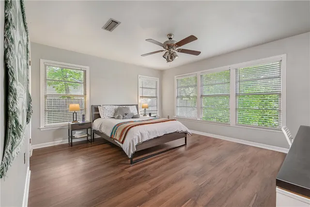 a bedroom with a large bed and a window