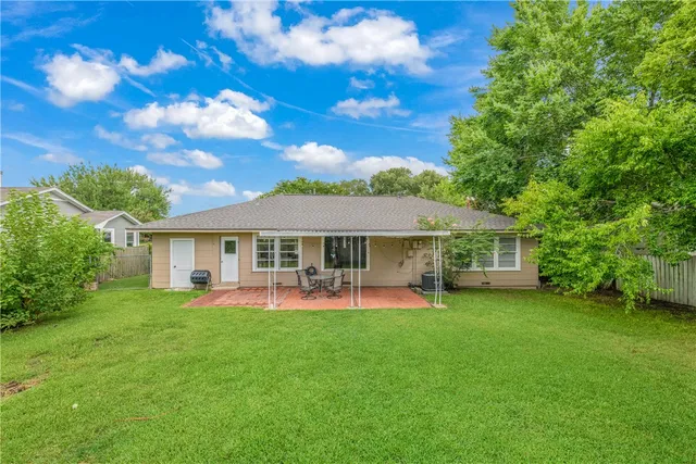 a view of a house with a yard porch and sitting area