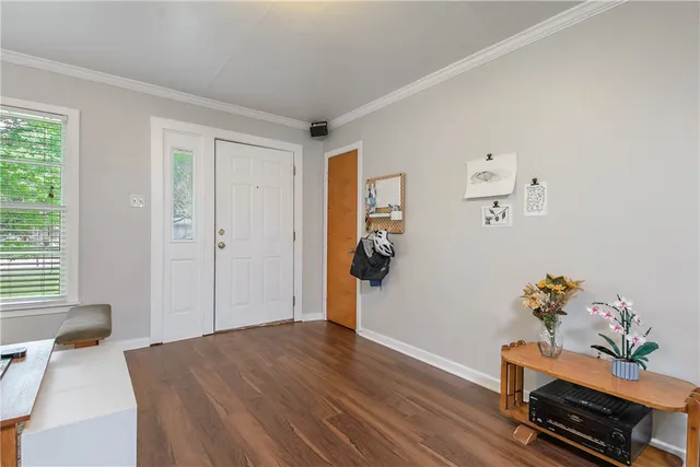 a bedroom with furniture and wooden floor