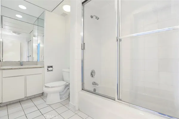 a bathroom with a shower toilet and sink