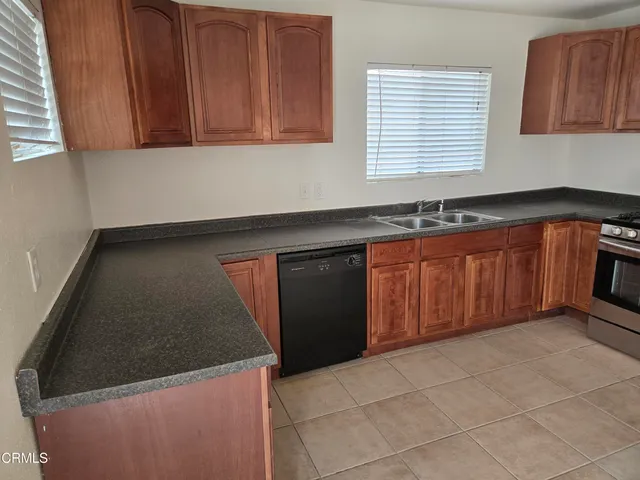 a kitchen with granite countertop a sink and cabinets