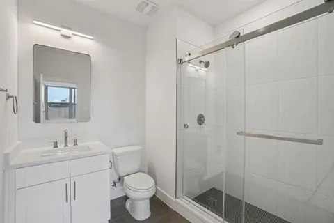 a bathroom with a sink toilet and shower