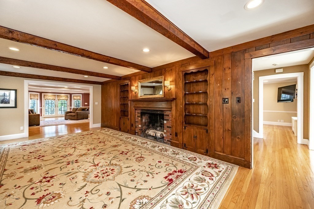 64 Garland Road Newton, MA 02459 - Photo 12 of 27 a view of a livingroom with wooden floor and a fireplace