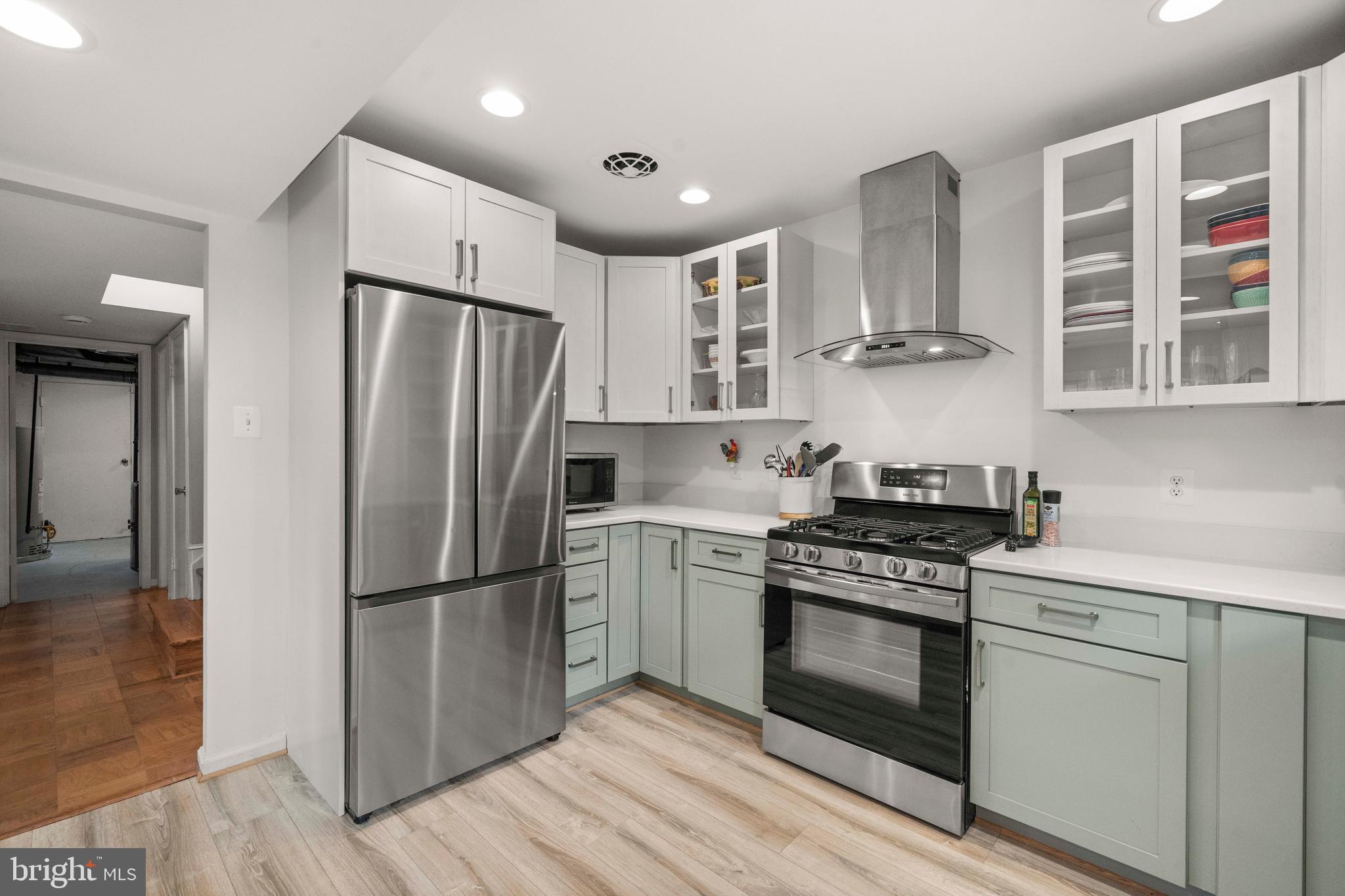 8414 Thames Street Springfield, VA 22151 - Photo 13 of 45 a kitchen with stainless steel appliances a stove a refrigerator and cabinets