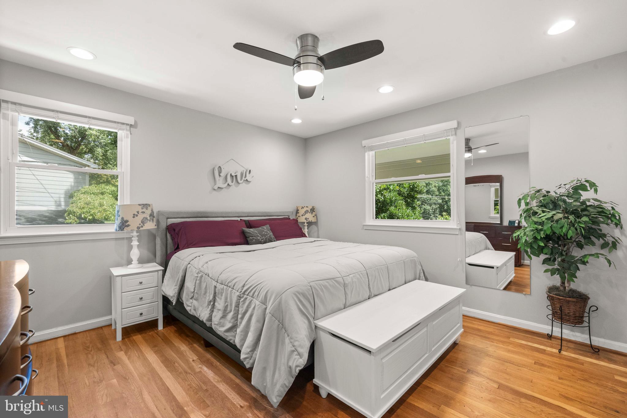 8414 Thames Street Springfield, VA 22151 - Photo 19 of 45 a bedroom with a large bed and a potted plant