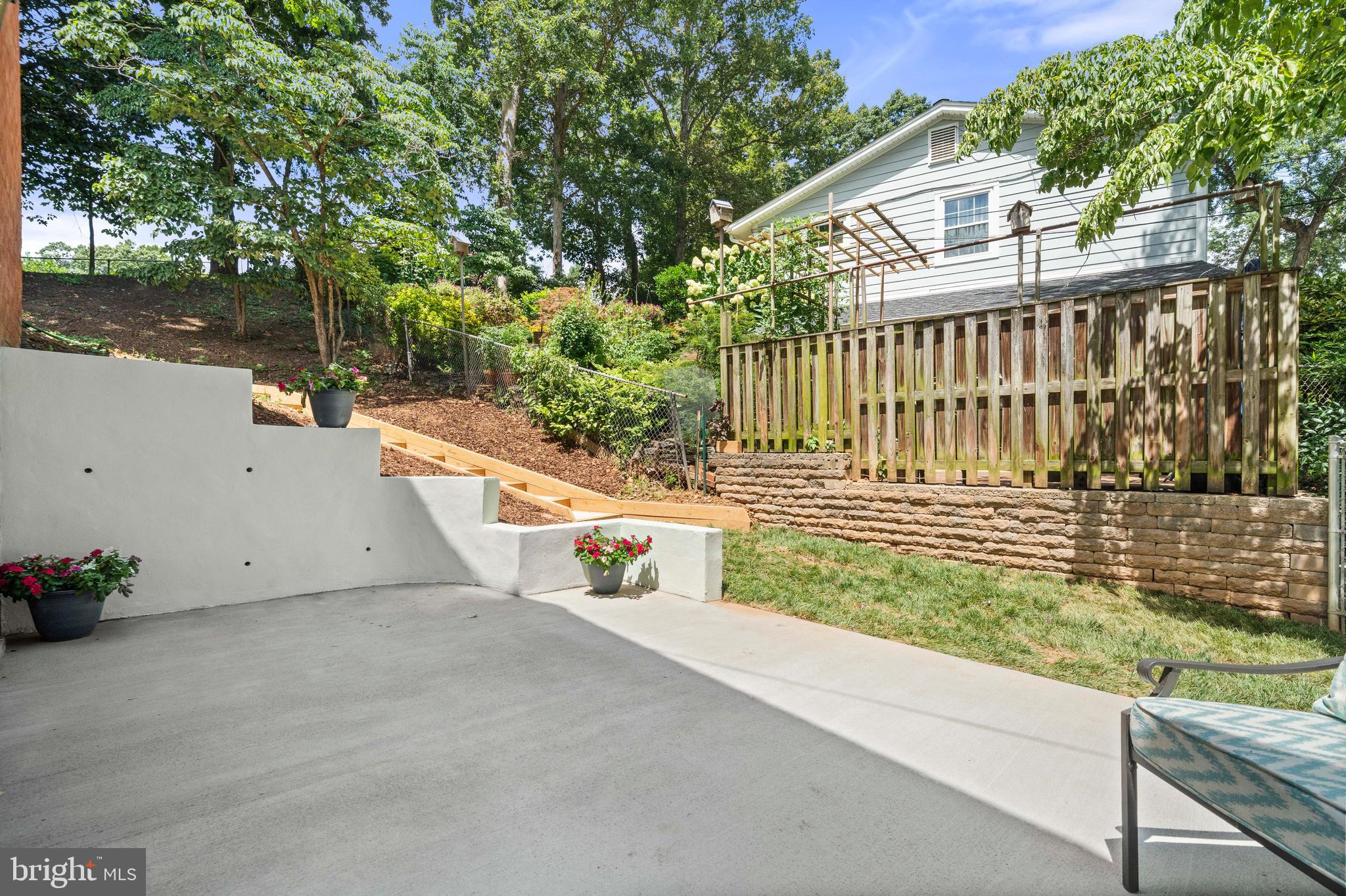 8414 Thames Street Springfield, VA 22151 - Photo 33 of 45 a view of a house with a small yard and wooden fence