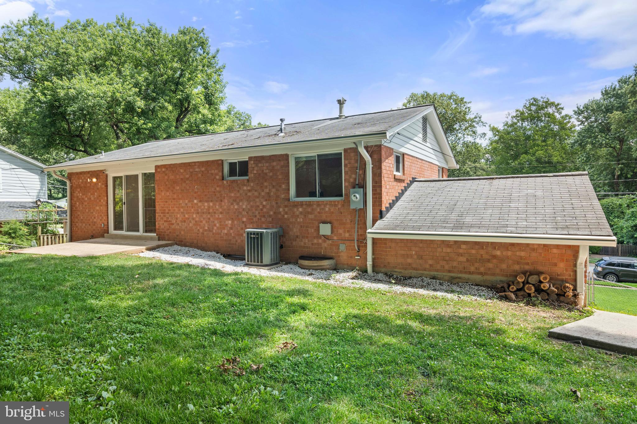 8414 Thames Street Springfield, VA 22151 - Photo 39 of 45 a front view of house with yard and trees in the background