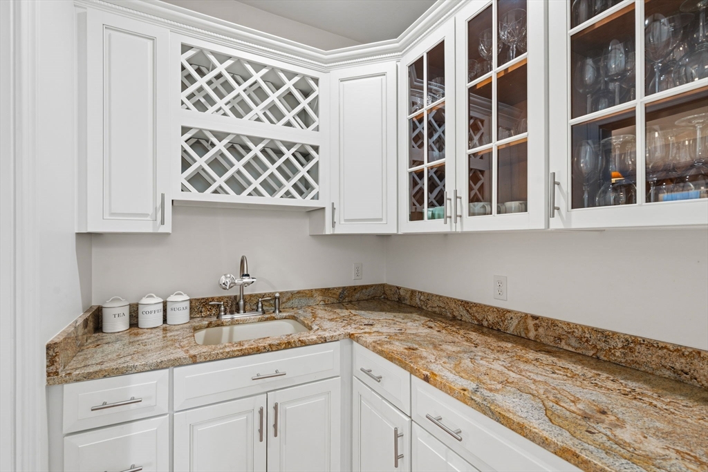 220 Newtown Road Acton, MA 01720 - Photo 5 of 39 a kitchen with stainless steel appliances granite countertop white cabinets and a granite counter tops