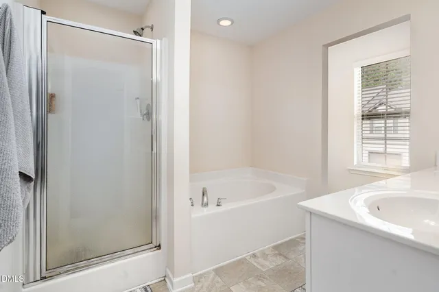 a bedroom with a bed a flat screen tv and dresser