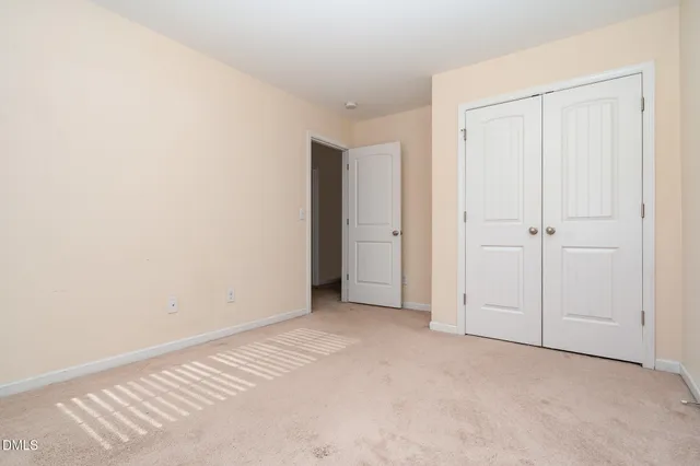 a view of walk in closet with clothes
