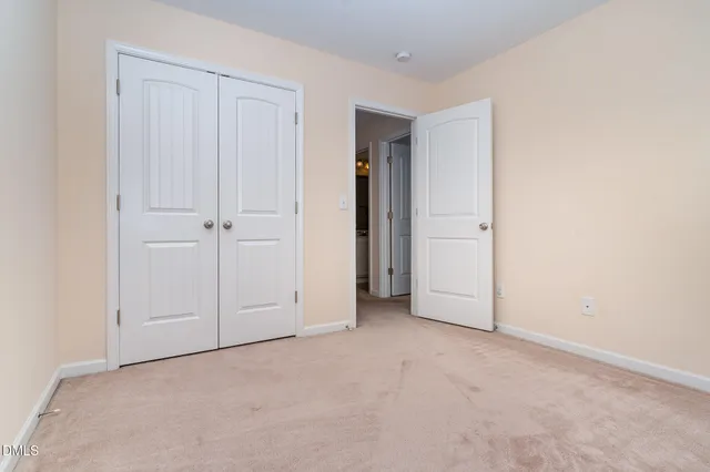 an empty room with closet area