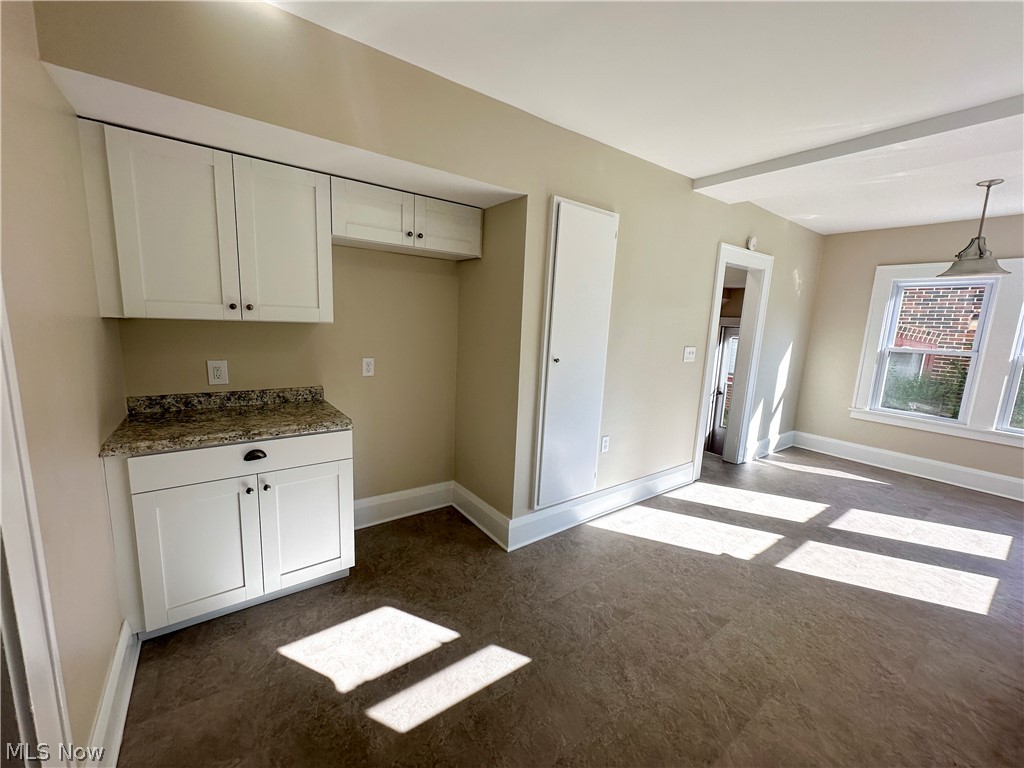3079 Kiwatha Road Youngstown, OH 44511 - Photo 12 of 27 Eat-in kitchen featuring white cabinets