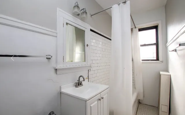 a bathroom with a sink mirror and vanity