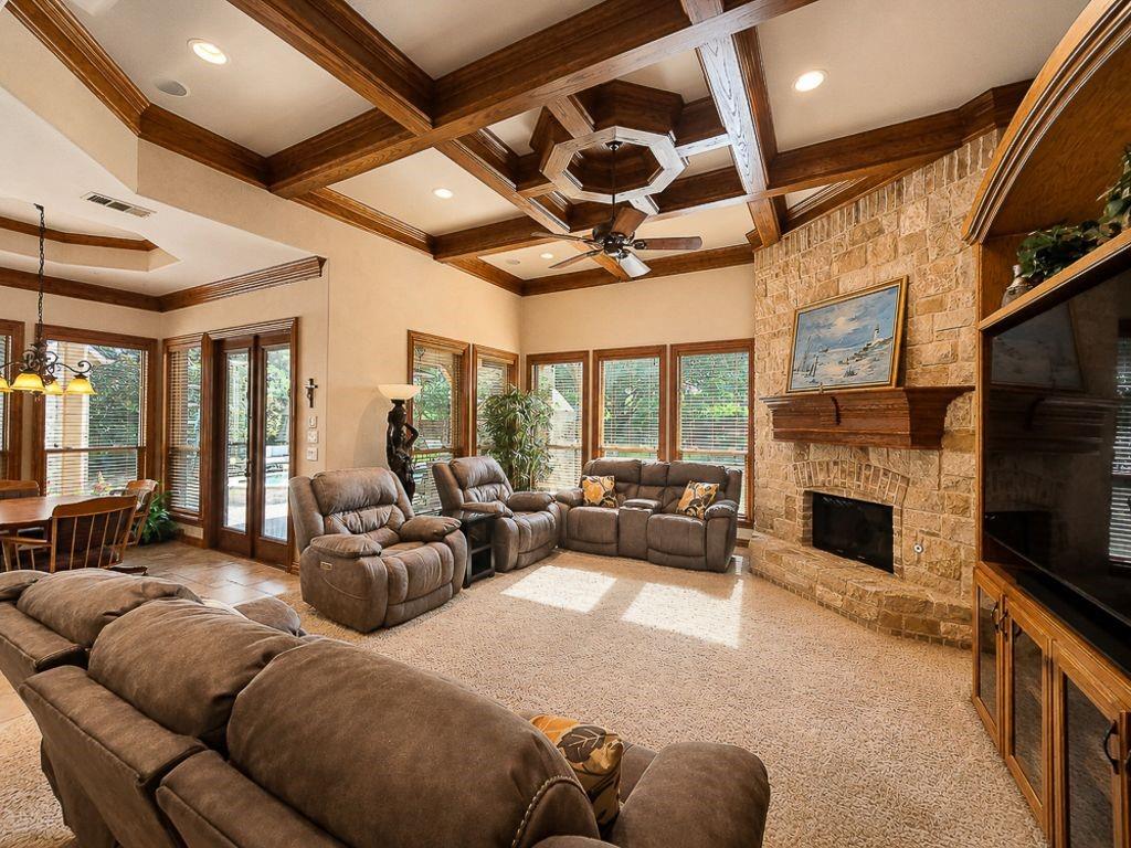 7005 Peter's Path Colleyville, TX 76034 - Photo 13 of 40 a living room with furniture a fireplace and a flat screen tv