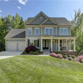 a front view of a house with yard and green space