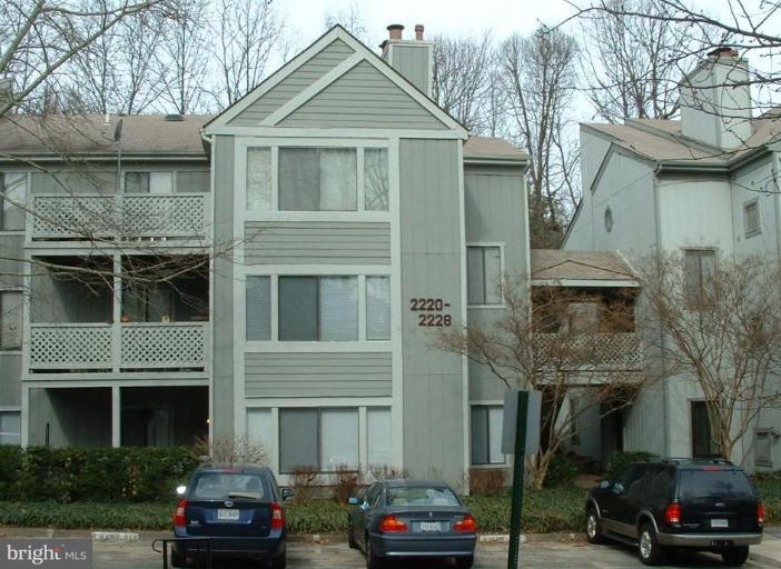 2223 Hunter's Run Drive, Unit 2223 Reston, VA 20191 - Photo 1 of 1 a front view of a building with parking area
