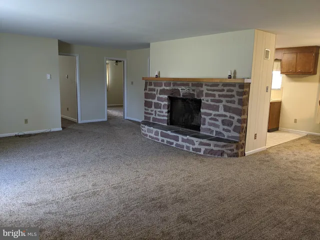 a view of empty room with fireplace
