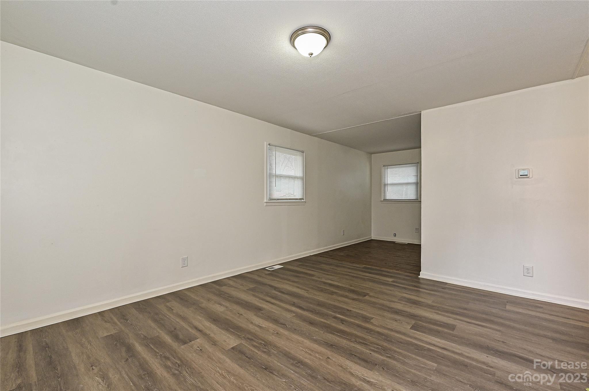 512 West Robinson Street Dallas, NC 28034 - Photo 13 of 17 an empty room with wooden floor and windows