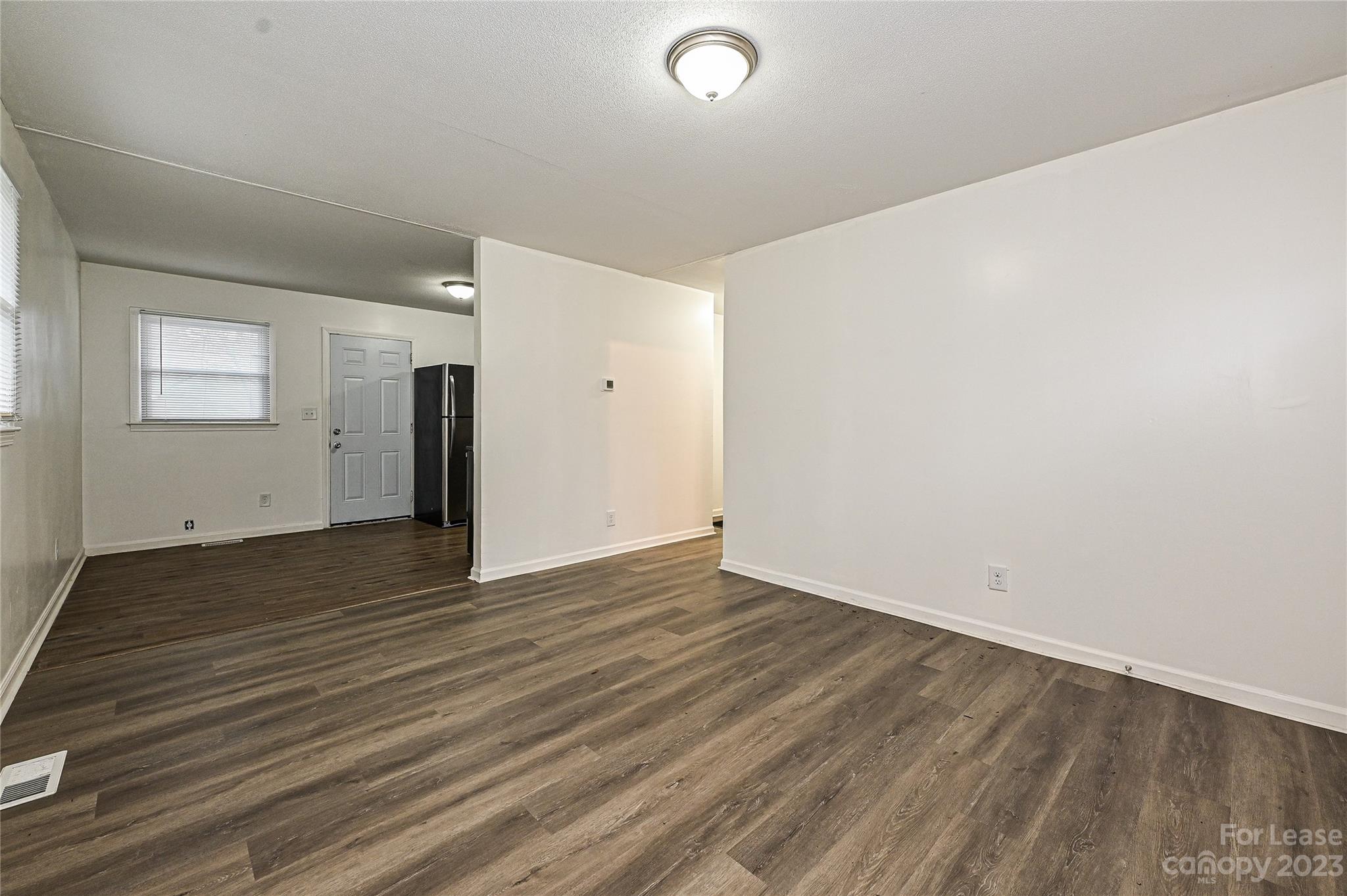 512 West Robinson Street Dallas, NC 28034 - Photo 14 of 17 a view of an empty room with wooden floor and a window