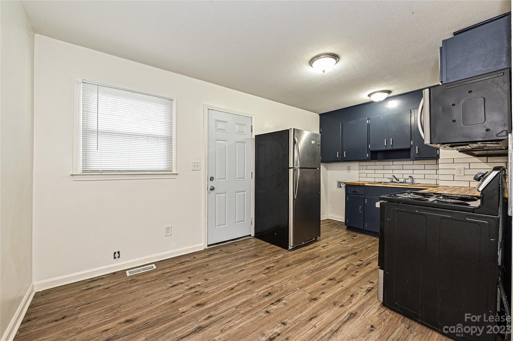 512 West Robinson Street Dallas, NC 28034 - Photo 15 of 17 a kitchen with stainless steel appliances granite countertop a refrigerator a stove a sink and a microwave oven