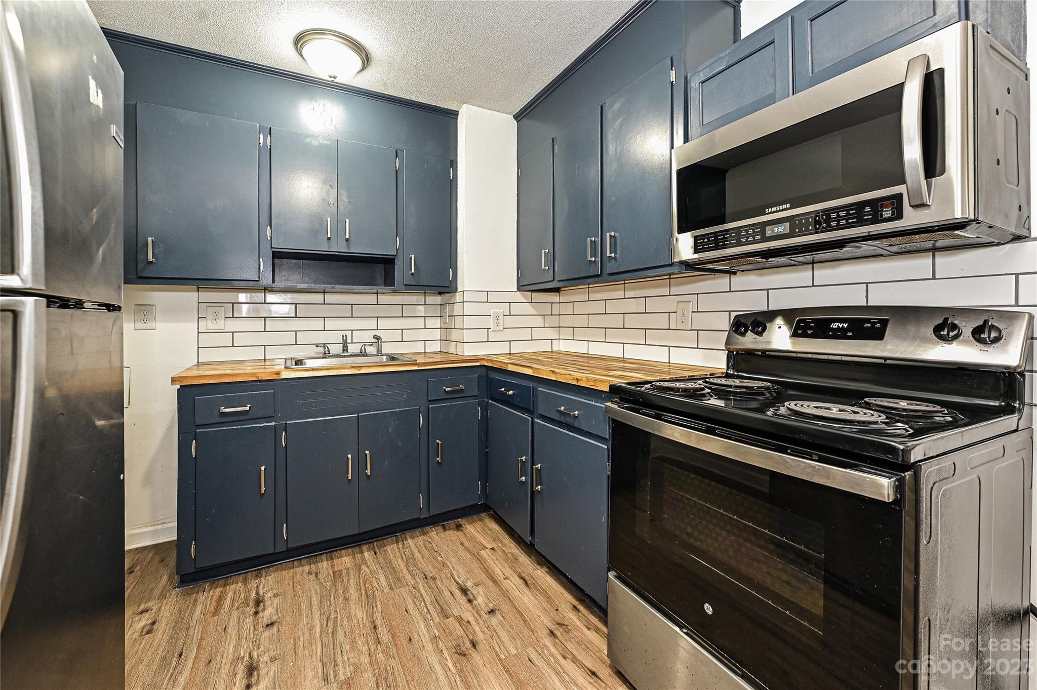 512 West Robinson Street Dallas, NC 28034 - Photo 17 of 17 a kitchen with a sink stove and microwave