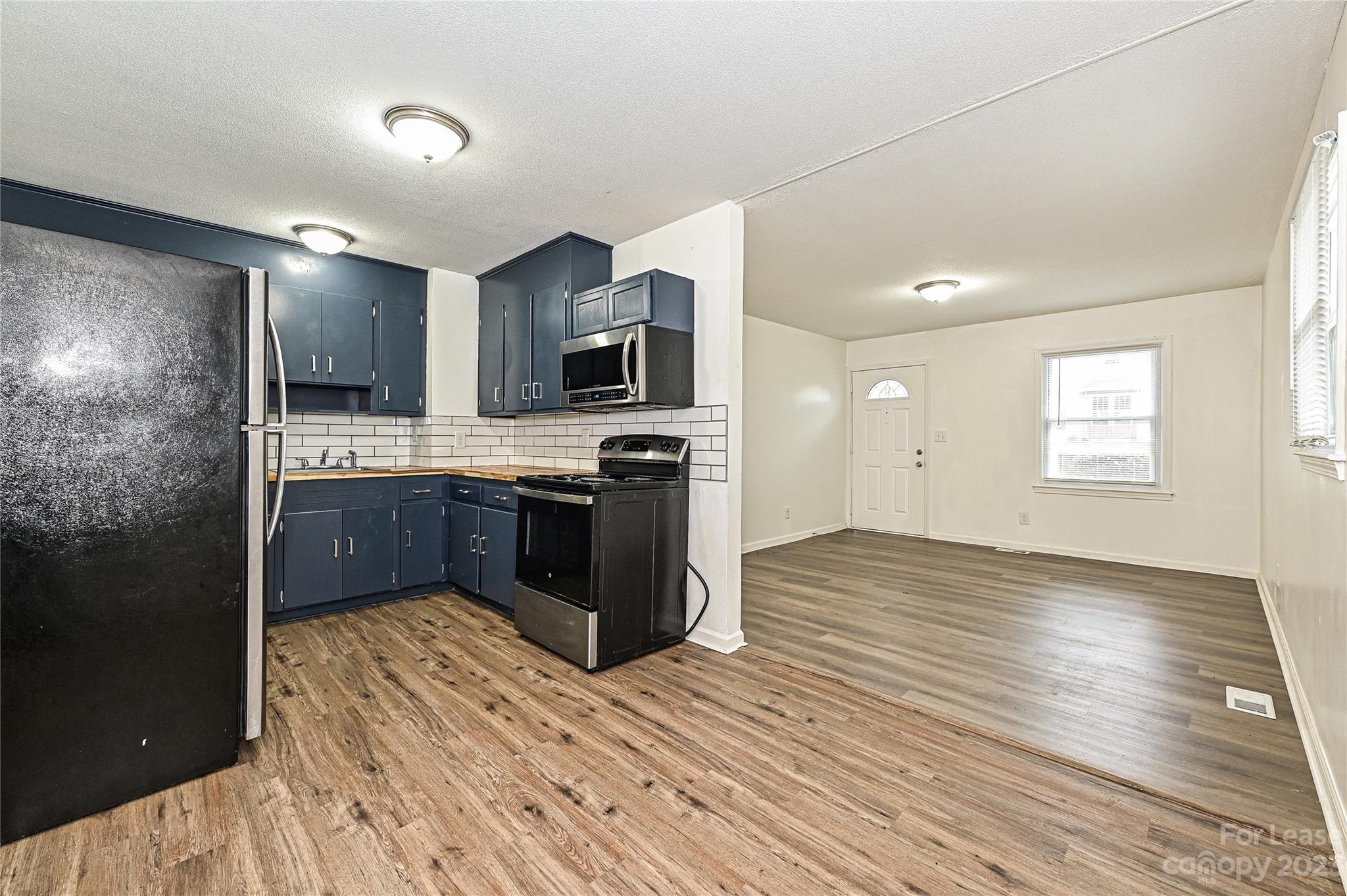 512 West Robinson Street Dallas, NC 28034 - Photo 4 of 17 a kitchen with stainless steel appliances a refrigerator sink and microwave