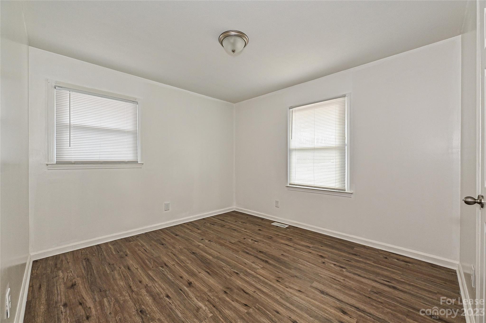 512 West Robinson Street Dallas, NC 28034 - Photo 7 of 17 an empty room with wooden floor and windows