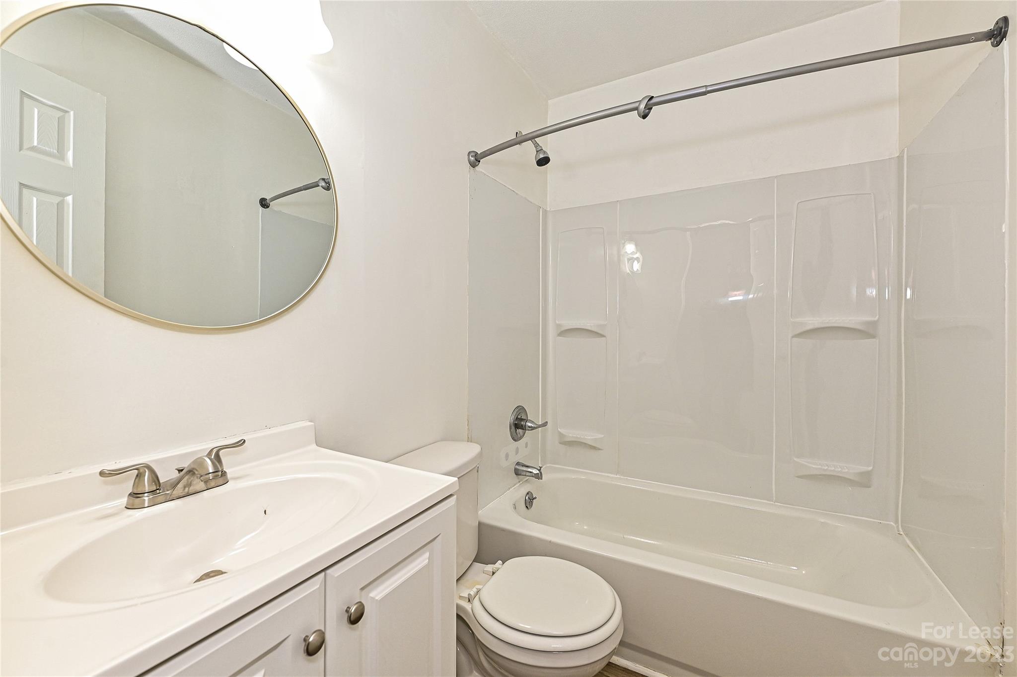 512 West Robinson Street Dallas, NC 28034 - Photo 8 of 17 a bathroom with a sink a toilet and a mirror