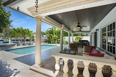 113 South Gordon Road Fort Lauderdale, FL 33301 - Photo 17 of 53 a view of a patio with table and chairs potted plants with floor to ceiling window and potted plants