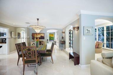 113 South Gordon Road Fort Lauderdale, FL 33301 - Photo 21 of 53 a view of a dining room with furniture and chandelier