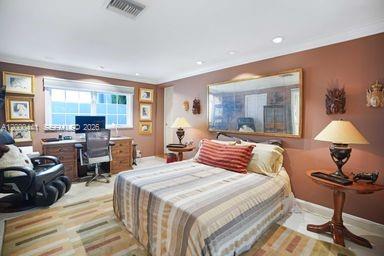 113 South Gordon Road Fort Lauderdale, FL 33301 - Photo 28 of 53 a bedroom with a bed and wooden floor
