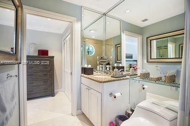 113 South Gordon Road Fort Lauderdale, FL 33301 - Photo 29 of 53 a en suite bathroom with a granite countertop sink and a mirror