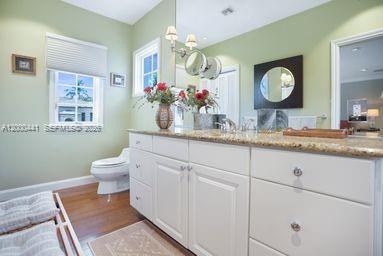 113 South Gordon Road Fort Lauderdale, FL 33301 - Photo 39 of 53 a bathroom with a toilet sink and mirror