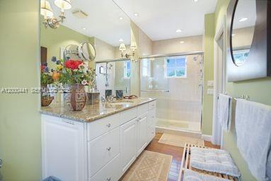 113 South Gordon Road Fort Lauderdale, FL 33301 - Photo 40 of 53 a bathroom with a granite countertop sink a mirror and a shower