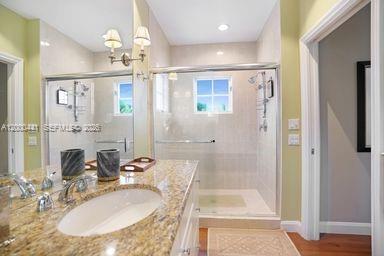113 South Gordon Road Fort Lauderdale, FL 33301 - Photo 41 of 53 a bathroom with a granite countertop sink a mirror and a shower