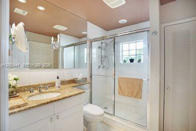 113 South Gordon Road Fort Lauderdale, FL 33301 - Photo 42 of 53 a bathroom with a granite countertop sink a toilet a mirror and shower
